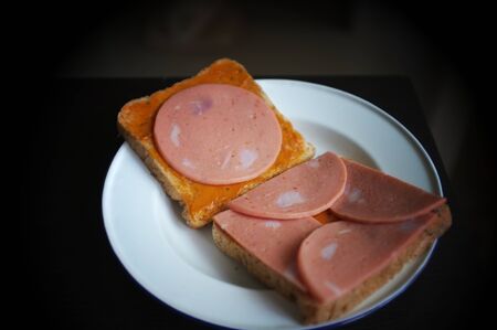 slice bread with pork ham on white dishの写真素材