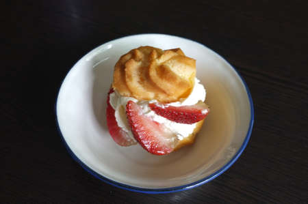 Tasty cupcake with strawberry on black wooden background .の写真素材