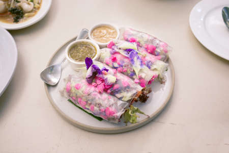 Beautiful and delicious Thai cuisine. Colorful appitizers made from edible flower or THAI NAME ( Miang Dok Mai )の写真素材