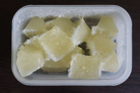 Lemon juice ice cubes with lemons . Frozen lemon juice preservation. Different ways to use lemon.