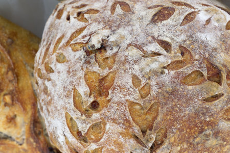 Bread close-up. Freshly baked sourdough bread with a golden crust  . Concept bakery , texture...