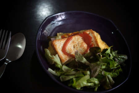 Sandwiches with egg, ham and toast cheese fried in dish