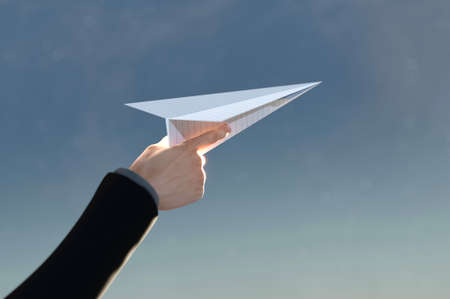 3D Illustration. 3D Rendering , Concept of business success  to the target , startup , creative idea . Business man hand on paper plane white flying on sky between cloud.の写真素材