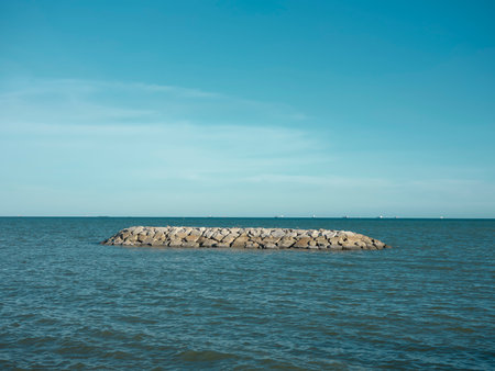 Sea beach with stone wall and sand at  beach , Map Ta phut , Rayong ,Thailand.
