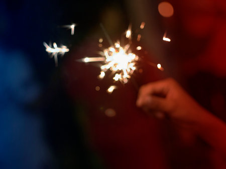 Holding a sparkler for special day . Concept birthday , HAPPY NEW YEAR ,  BLUR BACKGROUNDの写真素材