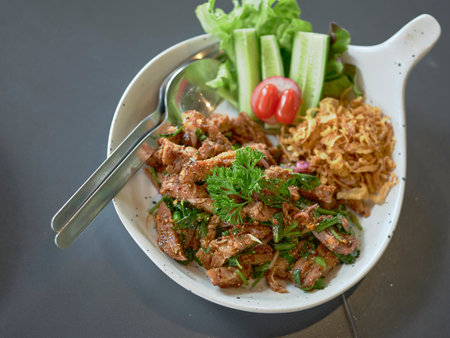 Thai street food.Spicy Grilled Pork Salad,grill pork with Charcoal and sliced  (Moo Nam Tok).の写真素材