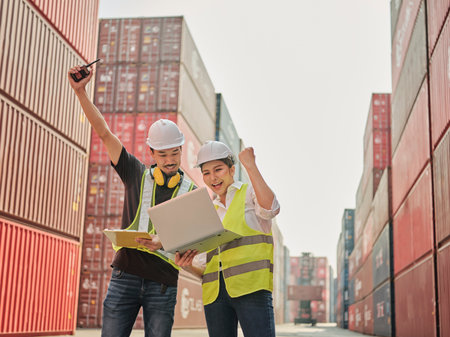 portrait of asian worker and engineer working with laptop in cargo port