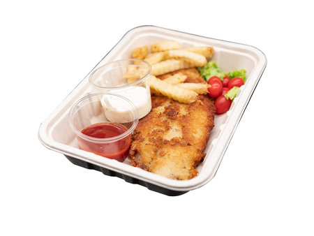 Deep fried cripy fish serves with fries and white sauce onの写真素材
