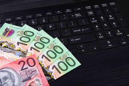 bank notes on a black computer keyboard