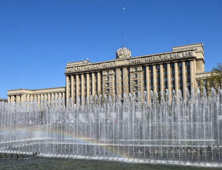 The house of Soviets and a rainbow in the fountain - administrative building in Moscow square in St. Petersburg Victory Day on May 9 against the blue sky.のeditorial素材