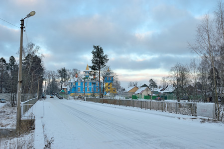 View of the bridge and the Church of blue and white colors of brother Ioann Churikov winter Sunny dayの写真素材