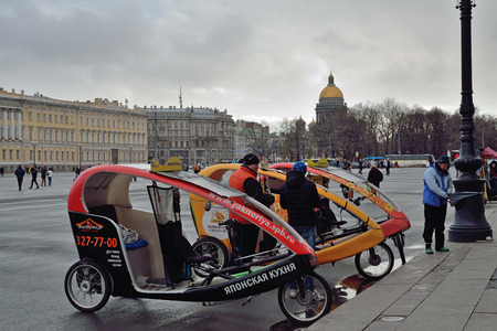 ST.PETERSBURG, RUSSIA - APRIL 28, 2016: Bicycle taxi on the Palace square in Saint-Petersburg