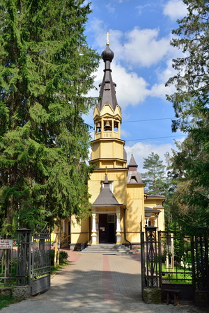 View of the entrance Bell tower of the Church of the Holy apostles Peter and Paul in the village of Vyritsa in the Leningrad region in summer Sunny day .の写真素材