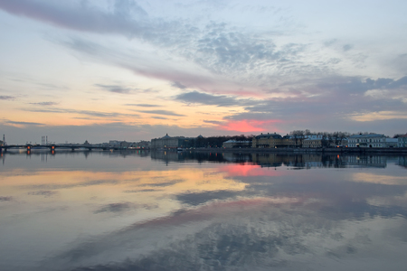 Sunset on the Neva river, the view of the University embankment in St. Petersburgの写真素材