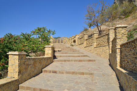 A stone staircase into the mountain lit by the sun. Crimeaの写真素材