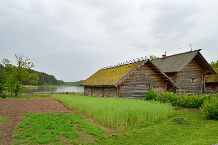 The garden and the old Russian log hut in Pushkin Mikhailovskoe summer cloudy dayの写真素材