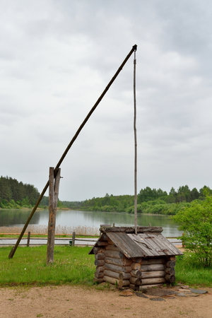 Vintage Russian well-pie in the Pushkin Mikhailovskoe summer cloudy dayの写真素材