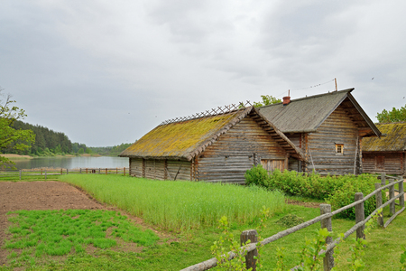 The garden and the old Russian log hut in Pushkin Mikhailovskoe summer cloudy dayの写真素材