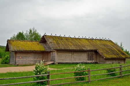 Old wooden log barn in the Museum of Pushkin Mikhailovskoe village summer cloudy dayの写真素材