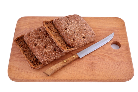 Rye morsel of bread on a wooden Board with a knife.の写真素材