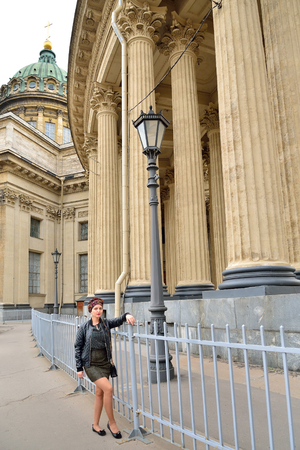 The girl tourist standing near the fence of the Kazan Cathedral in Saint-Petersburgの写真素材