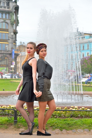 Pretty girls by the fountain on the background of the book - singer on Nevsky prospect in Saint-Petersburgの写真素材