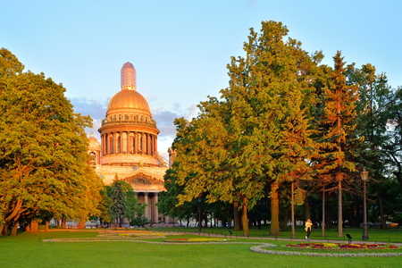 Alexander garden and sunlit St. Isaac's Cathedral at sunset in Saint-Petersburg.の写真素材