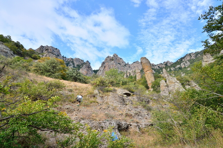Tourists walk through a mountain gorge in the valley of ghosts. Crimeaの写真素材