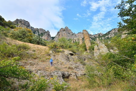 Tourists walk through a mountain gorge in the valley of ghosts. Crimeaの写真素材