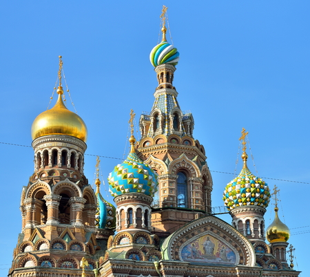 Dome of the Orthodox Cathedral of the Savior on spilled Blood illuminated by the sun against the blue skyの写真素材