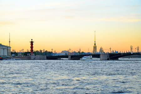 Sunset on the Neva river on the background of the Peter and Paul fortress and Rostral columnsの写真素材