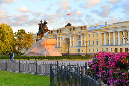 The bronze horseman monument on the background of the iron railings of the garden at sunset in Saint-Petersburg.の写真素材