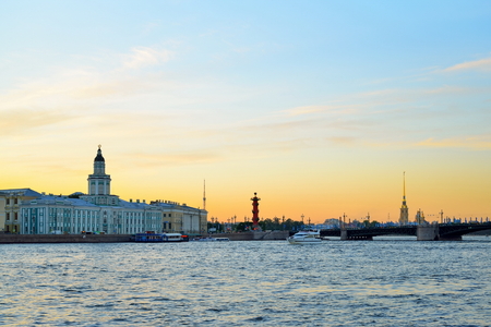 Sunset on the Neva river on the background of the Kunstkamera, the Peter and Paul fortress and Rostral columnsの写真素材