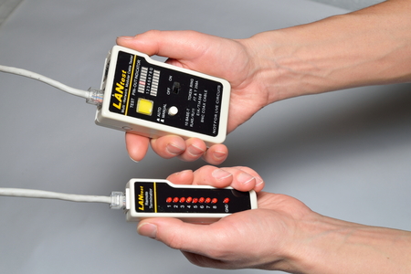 Hand of the master LAN check tester for crimped wire local area network.の写真素材