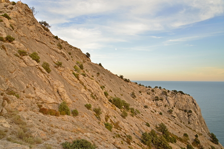 Rocky hillside by the sea at sunset. Crimeaの写真素材