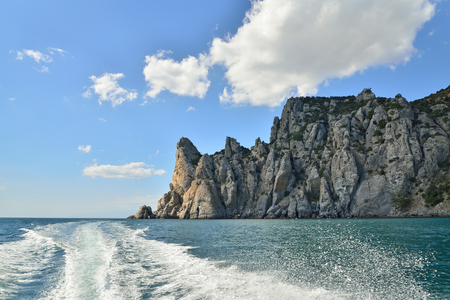 Wakes from boats on the backdrop of the cliffs. Crimea.. Sudakの写真素材