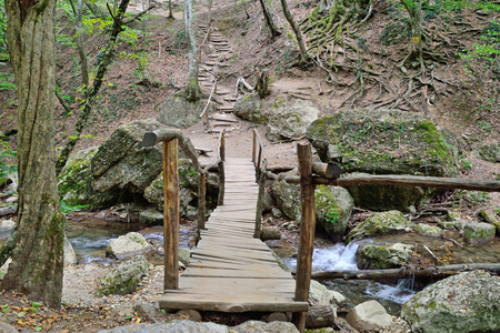 The wooden bridge at the waterfall Jur-Jur waterfall on the river East Ulu-Uzen. Crimeaの写真素材