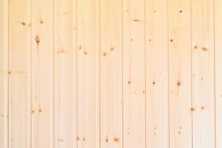 Background. Wall of vertical yellow wooden Board with knots-clapboard.の写真素材