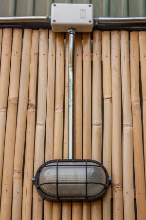 wall lamp on bamboo wall の写真素材