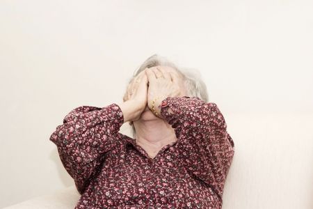 Portrait of family, crying old woman sittingの写真素材