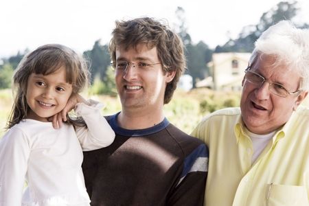 Portrait of family, grandfather and dad enjoying with his granddaughter outdoor