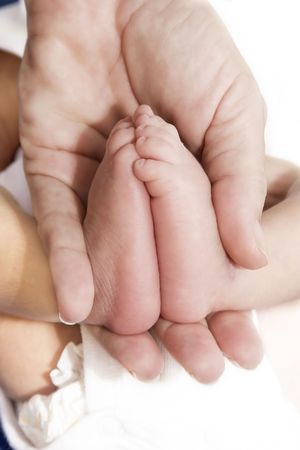 Adult´s hand and baby´s foot