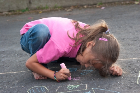Portrait of Beautiful Little Girl Painting Outdoorsの写真素材