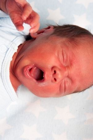 Portrait Of A Yawning Newborn Baby Boy Yawingの写真素材