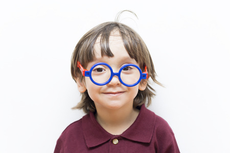 Portrait of Happy Little Boys Wearing Eyeglasses Indoorsの写真素材