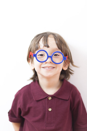 Portrait of Happy Little Boys Wearing Eyeglasses Indoorsの写真素材