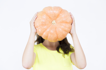 Happy Girl Playing with Pumpkin, Eating Healthy Foodの写真素材