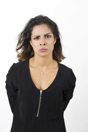 Portrait of Angry Young Woman Over White Backgroundの写真素材