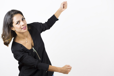 Attractive Smiling Woman showing empty open space for text on white background.の写真素材