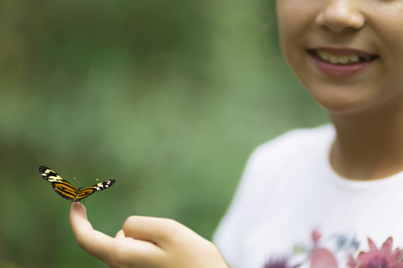 Portrait of Happy Girl Holding Butterfly Holding a Butterflyの写真素材